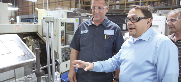 Mike Frumento on shopfloor with team member